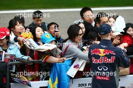 Daniil Kvyat (RUS) Red Bull Racing signs autographs for the fans. 09.04.2015. Formula 1 World Championship, Rd 3, Chinese Grand Prix, Shanghai, China, Preparation Day.