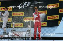 Third placed Sebastian Vettel (GER) Ferrari celebrates with the champagne on the podium. 10.05.2015. Formula 1 World Championship, Rd 5, Spanish Grand Prix, Barcelona, Spain, Race Day.