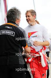 Sebastian Vettel (GER) Ferrari with Neil Dickie (GBR) Sahara Force India F1 Team. 03.07.2015. Formula 1 World Championship, Rd 9, British Grand Prix, Silverstone, England, Practice Day.