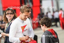 Sebastian Vettel (GER) Ferrari signs autographs for the fans. 03.07.2015. Formula 1 World Championship, Rd 9, British Grand Prix, Silverstone, England, Practice Day.
