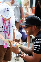 Lewis Hamilton (GBR) Mercedes AMG F1 with a young fan. 03.07.2015. Formula 1 World Championship, Rd 9, British Grand Prix, Silverstone, England, Practice Day.