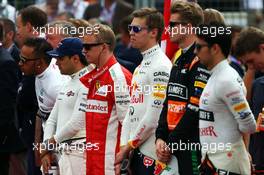 Kimi Raikkonen (FIN) Ferrari as the grid observes the national anthem. 05.07.2015. Formula 1 World Championship, Rd 9, British Grand Prix, Silverstone, England, Race Day.