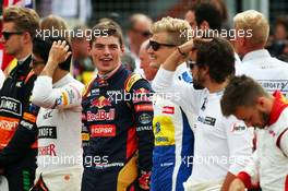 Max Verstappen (NLD) Scuderia Toro Rosso and Marcus Ericsson (SWE) Sauber F1 Team as the grid observes the national anthem. 05.07.2015. Formula 1 World Championship, Rd 9, British Grand Prix, Silverstone, England, Race Day.