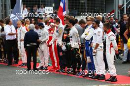 The drivers on the grid observe the national anthem. 05.07.2015. Formula 1 World Championship, Rd 9, British Grand Prix, Silverstone, England, Race Day.