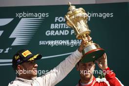 Race winner Lewis Hamilton (GBR) Mercedes AMG F1 celebrates on the podium with Sebastian Vettel (GER) Ferrari. 05.07.2015. Formula 1 World Championship, Rd 9, British Grand Prix, Silverstone, England, Race Day.