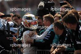 Race winner Lewis Hamilton (GBR) Mercedes AMG F1 celebrates with the team in parc ferme. 05.07.2015. Formula 1 World Championship, Rd 9, British Grand Prix, Silverstone, England, Race Day.