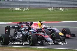 Fernando Alonso (ESP) McLaren MP4-30 and Daniil Kvyat (RUS) Red Bull Racing RB11 battle for position. 05.07.2015. Formula 1 World Championship, Rd 9, British Grand Prix, Silverstone, England, Race Day.