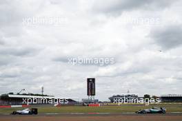 Valtteri Bottas (FIN) Williams FW37 leads Lewis Hamilton (GBR) Mercedes AMG F1 W06. 05.07.2015. Formula 1 World Championship, Rd 9, British Grand Prix, Silverstone, England, Race Day.