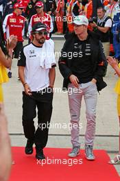 (L to R): Fernando Alonso (ESP) McLaren with Nico Hulkenberg (GER) Sahara Force India F1 on the drivers parade. 05.07.2015. Formula 1 World Championship, Rd 9, British Grand Prix, Silverstone, England, Race Day.