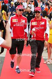 (L to R): Kimi Raikkonen (FIN) Ferrari with team mate Sebastian Vettel (GER) Ferrari on the drivers parade. 05.07.2015. Formula 1 World Championship, Rd 9, British Grand Prix, Silverstone, England, Race Day.