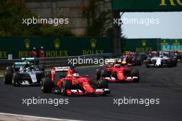 Sebastian Vettel (GER) Ferrari SF15-T leads at the start of the race. 26.07.2015. Formula 1 World Championship, Rd 10, Hungarian Grand Prix, Budapest, Hungary, Race Day.