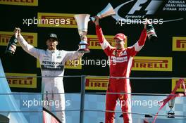 (L to R): Race winner Lewis Hamilton (GBR) Mercedes AMG F1 celebrates with second placed Sebastian Vettel (GER) Ferrari on the podium. 06.09.2015. Formula 1 World Championship, Rd 12, Italian Grand Prix, Monza, Italy, Race Day.