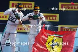 (L to R): Race winner Lewis Hamilton (GBR) Mercedes AMG F1 and third placed Felipe Massa (BRA) Williams celebrate on the podium. 06.09.2015. Formula 1 World Championship, Rd 12, Italian Grand Prix, Monza, Italy, Race Day.
