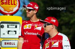 (L to R): Sebastian Vettel (GER) Ferrari and team mate Kimi Raikkonen (FIN) Ferrari on the Monza banking at a Shell photoshoot. 05.09.2015. Formula 1 World Championship, Rd 12, Italian Grand Prix, Monza, Italy, Qualifying Day.