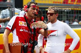 Sebastian Vettel (GER) Ferrari with Riccardo Adami (ITA) Ferrari Race Engineer on the grid. 27.09.2015. Formula 1 World Championship, Rd 14, Japanese Grand Prix, Suzuka, Japan, Race Day.