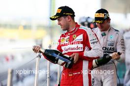 Sebastian Vettel (GER) Ferrari celebrates his third position with the champagne on the podium. 27.09.2015. Formula 1 World Championship, Rd 14, Japanese Grand Prix, Suzuka, Japan, Race Day.