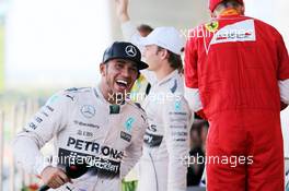 (L to R): Race winner Lewis Hamilton (GBR) Mercedes AMG F1 celebrates on the podium with third placed Sebastian Vettel (GER) Ferrari. 27.09.2015. Formula 1 World Championship, Rd 14, Japanese Grand Prix, Suzuka, Japan, Race Day.