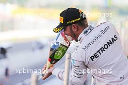Race winner Lewis Hamilton (GBR) Mercedes AMG F1 celebrates with the champagne on the podium. 27.09.2015. Formula 1 World Championship, Rd 14, Japanese Grand Prix, Suzuka, Japan, Race Day.