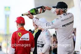 Race winner Lewis Hamilton (GBR) Mercedes AMG F1 celebrates on the podium with third placed Sebastian Vettel (GER) Ferrari. 27.09.2015. Formula 1 World Championship, Rd 14, Japanese Grand Prix, Suzuka, Japan, Race Day.