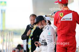 (L to R): Race winner Lewis Hamilton (GBR) Mercedes AMG F1 celebrates on the podium with third placed Sebastian Vettel (GER) Ferrari. 27.09.2015. Formula 1 World Championship, Rd 14, Japanese Grand Prix, Suzuka, Japan, Race Day.