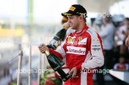 Sebastian Vettel (GER) Ferrari celebrates his third position with the champagne on the podium. 27.09.2015. Formula 1 World Championship, Rd 14, Japanese Grand Prix, Suzuka, Japan, Race Day.