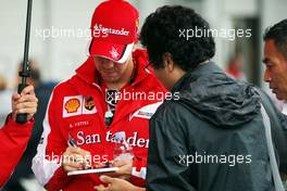 Sebastian Vettel (GER) Ferrari signs autographs for the fans. 24.09.2015. Formula 1 World Championship, Rd 14, Japanese Grand Prix, Suzuka, Japan, Preparation Day.