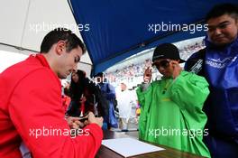 Alexander Rossi (USA) Manor Marussia F1 Team signs autographs for the fans. 24.09.2015. Formula 1 World Championship, Rd 14, Japanese Grand Prix, Suzuka, Japan, Preparation Day.