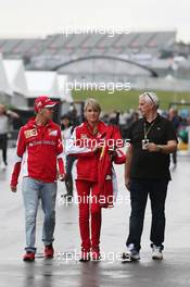 Sebastian Vettel (GER) Ferrari with Britta Roeske (AUT) Ferrari Press Officer (Centre). 24.09.2015. Formula 1 World Championship, Rd 14, Japanese Grand Prix, Suzuka, Japan, Preparation Day.