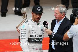 Third palced Lewis Hamilton (GBR) Mercedes AMG F1 on the podium with Martin Brundle (GBR) Sky Sports Commentator. 24.05.2015. Formula 1 World Championship, Rd 6, Monaco Grand Prix, Monte Carlo, Monaco, Race Day.