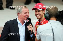 Martin Brundle (GBR) Sky Sports Commentator with Sebastian Vettel (GER) Ferrari on the podium. 24.05.2015. Formula 1 World Championship, Rd 6, Monaco Grand Prix, Monte Carlo, Monaco, Race Day.