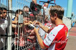 Sebastian Vettel (GER) Ferrari signs autographs for the fans. 20.05.2015. Formula 1 World Championship, Rd 6, Monaco Grand Prix, Monte Carlo, Monaco, Preparation Day.