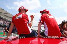 (L to R): Sebastian Vettel (GER) Ferrari with Kimi Raikkonen (FIN) Ferrari on the drivers parade. 01.11.2015. Formula 1 World Championship, Rd 17, Mexican Grand Prix, Mexixo City, Mexico, Race Day.