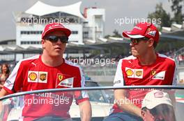 (L to R): Kimi Raikkonen (FIN) Ferrari with Sebastian Vettel (GER) Ferrari on the drivers parade. 01.11.2015. Formula 1 World Championship, Rd 17, Mexican Grand Prix, Mexixo City, Mexico, Race Day.