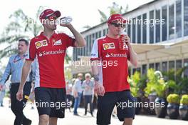 (L to R): Sebastian Vettel (GER) Ferrari with team mate Kimi Raikkonen (FIN) Ferrari. 27.03.2015. Formula 1 World Championship, Rd 2, Malaysian Grand Prix, Sepang, Malaysia, Friday.