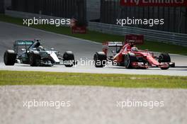Lewis Hamilton (GBR) Mercedes AMG F1 W06 and Sebastian Vettel (GER) Ferrari SF15-T battle for the lead of the race. 29.03.2015. Formula 1 World Championship, Rd 2, Malaysian Grand Prix, Sepang, Malaysia, Sunday.