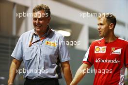 (L to R): Mario Isola (ITA) Pirelli Racing Manager with Sebastian Vettel (GER) Ferrari. 18.09.2015. Formula 1 World Championship, Rd 13, Singapore Grand Prix, Singapore, Singapore, Practice Day.