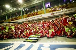 Race winner Sebastian Vettel (GER) Ferrari and third placed Kimi Raikkonen (FIN) Ferrari celebrate with the team. 20.09.2015. Formula 1 World Championship, Rd 13, Singapore Grand Prix, Singapore, Singapore, Race Day.