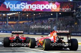 Sebastian Vettel (GER) Ferrari SF15-T and Kimi Raikkonen (FIN) Ferrari SF15-T at the pit lane exit. 19.09.2015. Formula 1 World Championship, Rd 13, Singapore Grand Prix, Singapore, Singapore, Qualifying Day.