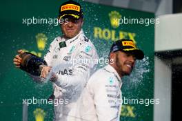 Race winner Nico Rosberg (GER) Mercedes AMG F1 celebrates with the champagne with second placed team mate Lewis Hamilton (GBR) Mercedes AMG F1. 20.03.2016. Formula 1 World Championship, Rd 1, Australian Grand Prix, Albert Park, Melbourne, Australia, Race Day.