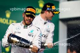 Lewis Hamilton (GBR) Mercedes AMG F1 celebrates his second place with the champagne on the podium. 20.03.2016. Formula 1 World Championship, Rd 1, Australian Grand Prix, Albert Park, Melbourne, Australia, Race Day.