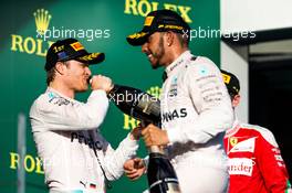 Race winner Nico Rosberg (GER) Mercedes AMG F1 celebrates with the champagne on the podium with team mate Lewis Hamilton (GBR) Mercedes AMG F1 and Sebastian Vettel (GER) Ferrari. 20.03.2016. Formula 1 World Championship, Rd 1, Australian Grand Prix, Albert Park, Melbourne, Australia, Race Day.