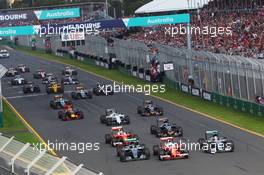 (L to R): Nico Rosberg (GER) Mercedes AMG F1 W07 Hybrid, Sebastian Vettel (GER) Ferrari SF16-H, and Lewis Hamilton (GBR) Mercedes AMG F1 W07 Hybrid at the start of the race. 20.03.2016. Formula 1 World Championship, Rd 1, Australian Grand Prix, Albert Park, Melbourne, Australia, Race Day.