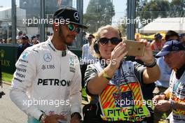 Lewis Hamilton (GBR) Mercedes AMG F1 with a marshal. 20.03.2016. Formula 1 World Championship, Rd 1, Australian Grand Prix, Albert Park, Melbourne, Australia, Race Day.