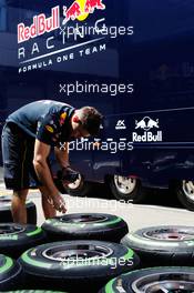 Red Bull Racing mechanic with Pirelli tyres. 30.06.2016. Formula 1 World Championship, Rd 9, Austrian Grand Prix, Spielberg, Austria, Preparation Day.