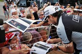 Sergio Perez (MEX) Sahara Force India F1 signs autographs for the fans. 30.06.2016. Formula 1 World Championship, Rd 9, Austrian Grand Prix, Spielberg, Austria, Preparation Day.
