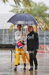 Jolyon Palmer (GBR) Renault Sport F1 Team in a wet and rainy paddock with Aurelie Donzelot (FRA) Renault Sport F1 Team Media Communications Manager. 31.03.2016. Formula 1 World Championship, Rd 2, Bahrain Grand Prix, Sakhir, Bahrain, Preparation Day.