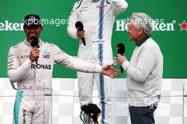 (L to R): race winner Lewis Hamilton (GBR) Mercedes AMG F1 with Michael Douglas (USA) Actor on the podium. 12.06.2016. Formula 1 World Championship, Rd 7, Canadian Grand Prix, Montreal, Canada, Race Day.