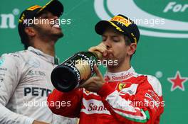 (L to R): Race winner Lewis Hamilton (GBR) Mercedes AMG F1 and race winner Sebastian Vettel (GER) Ferrari celebrate on the podium. 12.06.2016. Formula 1 World Championship, Rd 7, Canadian Grand Prix, Montreal, Canada, Race Day.