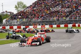 Sebastian Vettel (GER) Ferrari SF16-H leads at the start of the race as Nico Rosberg (GER) Mercedes AMG F1 W07 Hybrid rejoins the circuit. 12.06.2016. Formula 1 World Championship, Rd 7, Canadian Grand Prix, Montreal, Canada, Race Day.