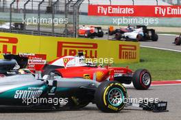 Kimi Raikkonen (FIN) Ferrari SF16-H and Lewis Hamilton (GBR) Mercedes AMG F1 W07 Hybrid with broken front wings at the start of the race. 17.04.2016. Formula 1 World Championship, Rd 3, Chinese Grand Prix, Shanghai, China, Race Day.